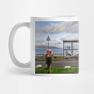 People chatting around a bus shelter - Lochranza, Scotland Mug